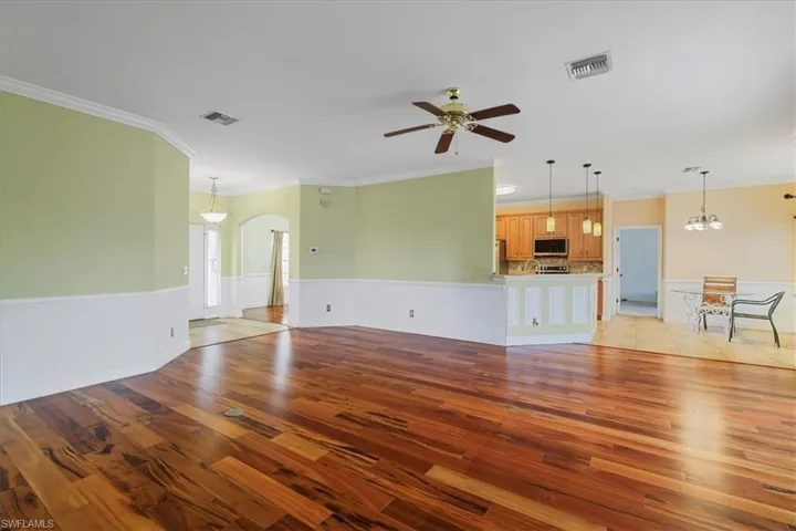 Spare room with ornamental molding and wood finished floors