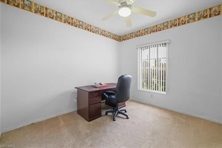 Empty room with carpet flooring and a ceiling fan