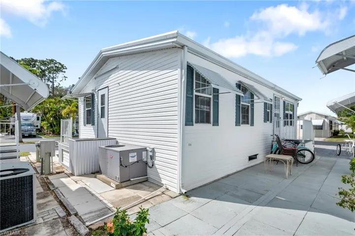 View of property exterior with crawl space, a patio area, and central air condition unit