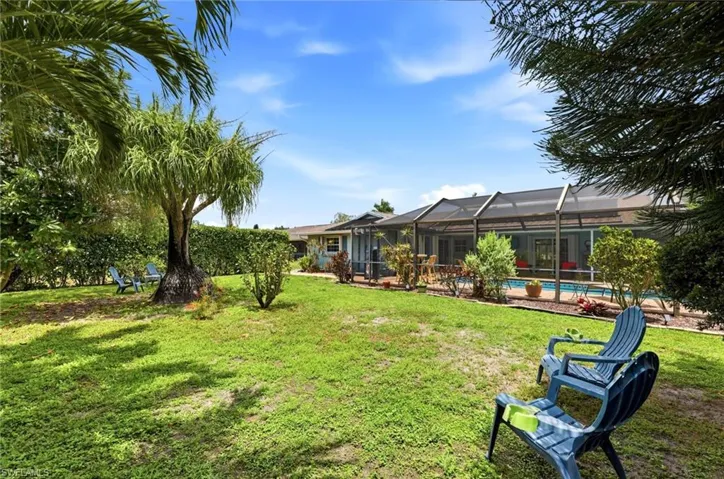 Back of yard looking towards pool cage