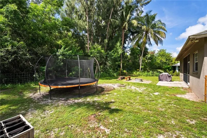 View of yard with a trampoline