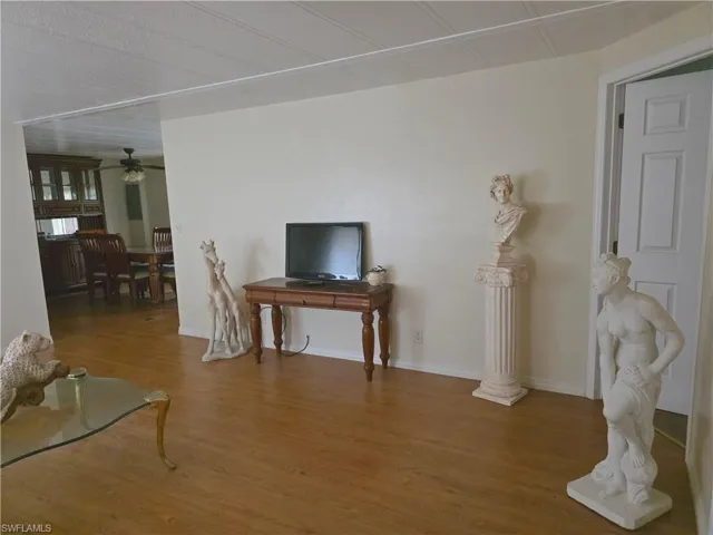 Living room featuring ceiling fan and wood finished floors