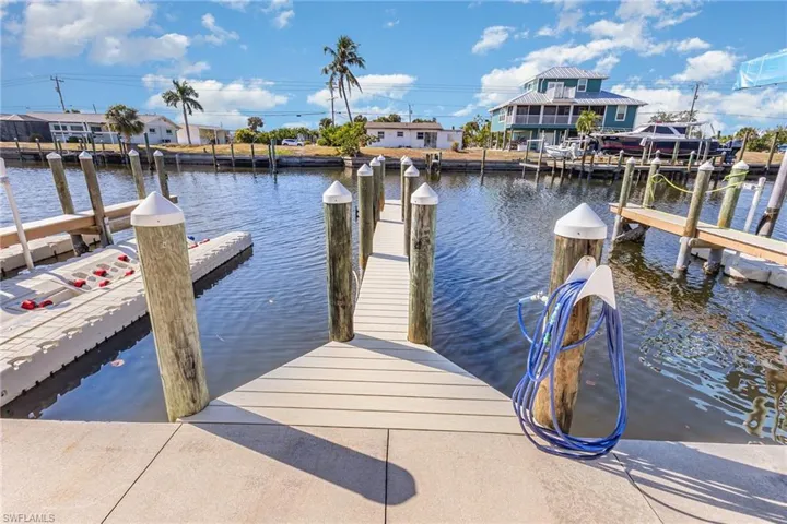 Dock area with a water view and a residential view