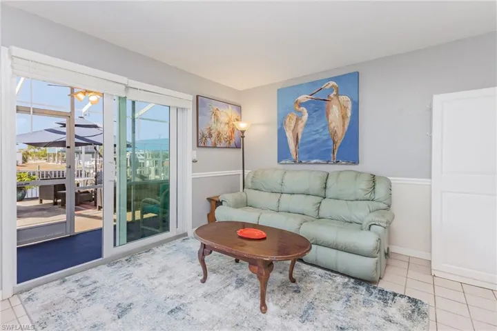 Living area featuring tile patterned flooring and a sunroom