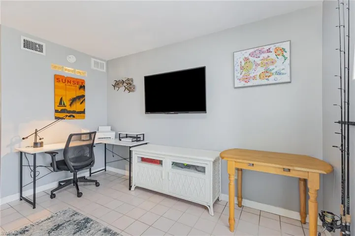 Office with baseboards and light tile patterned flooring