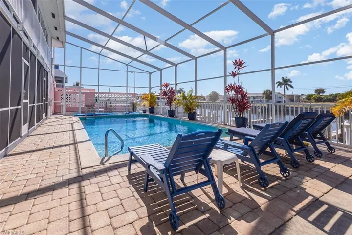 Outdoor pool featuring a lanai and patio
