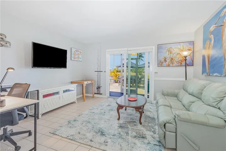 Living area featuring a desk and light tile patterned floors