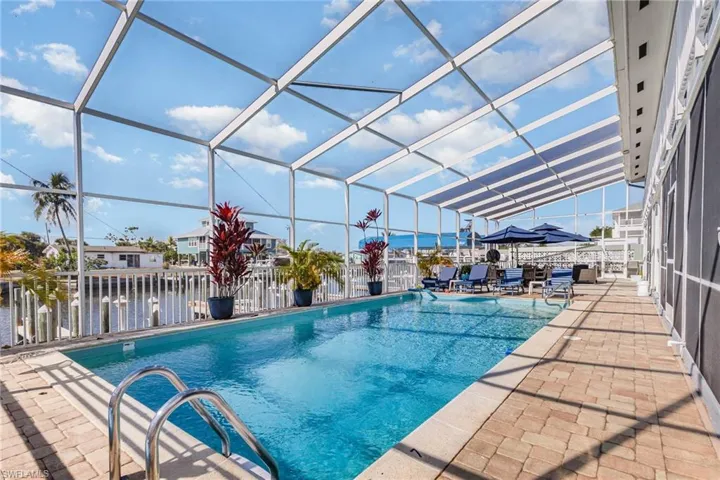 Outdoor pool with screen enclosure and patio