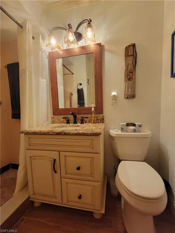 Bathroom featuring oversized vanity and toilet