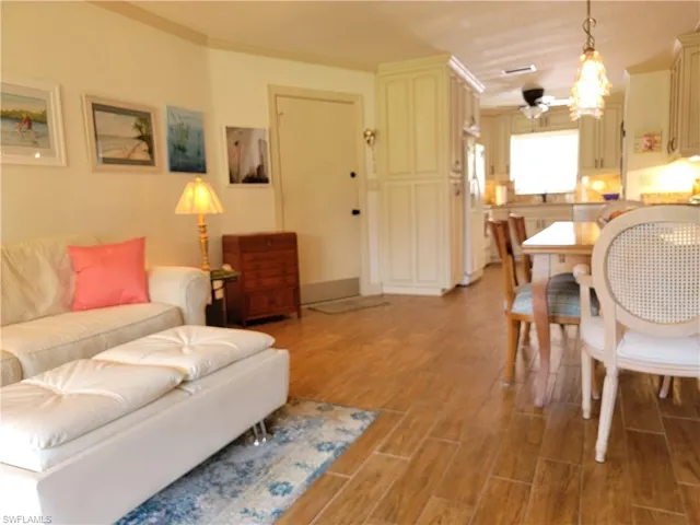 Living room with hardwood / wood-style flooring and ceiling fan
