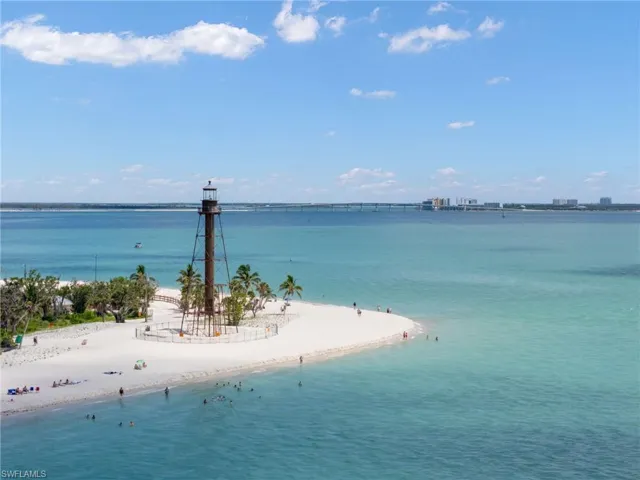 Water view featuring nearby beach and a pier