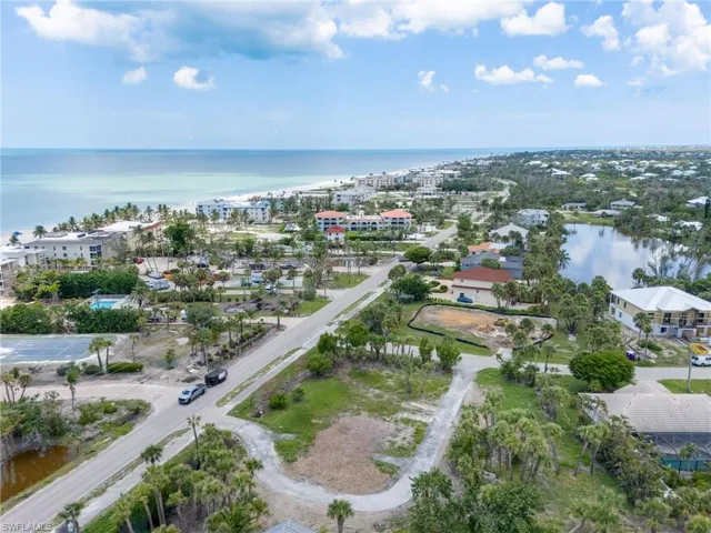 Aerial view of property and surrounding area featuring a nearby body of water