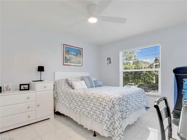 Tiled bedroom with ceiling fan