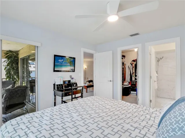 Bedroom featuring access to outside, a spacious closet, and ceiling fan
