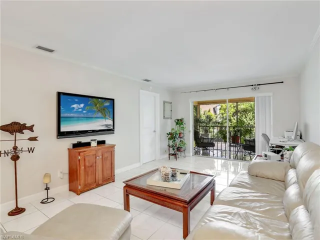 Tiled living room featuring ornamental molding
