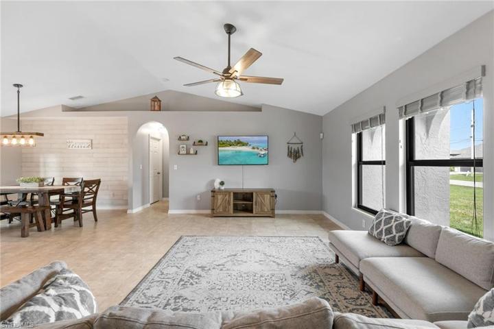 Cathedral ceilings and shiplap accent wall in dining area.