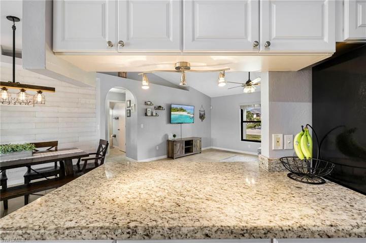 Enjoy granite countertops in your well lit kitchen space.