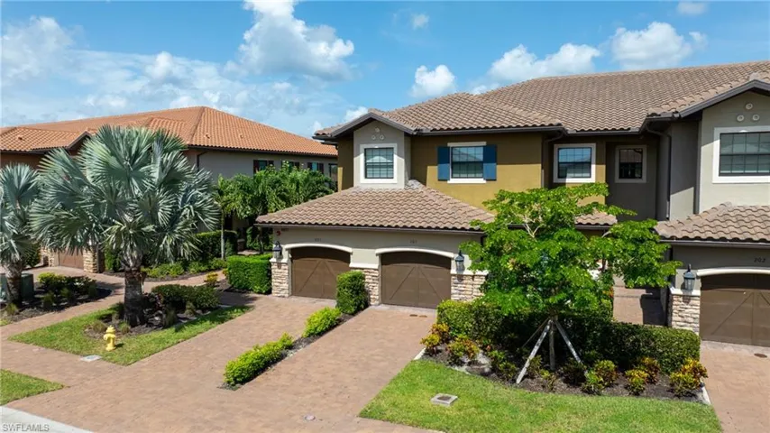Mediterranean / spanish house featuring stucco siding, stone siding, and a tile roof