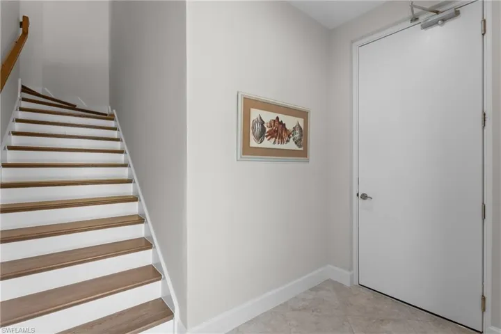 Staircase featuring baseboards and tile patterned flooring