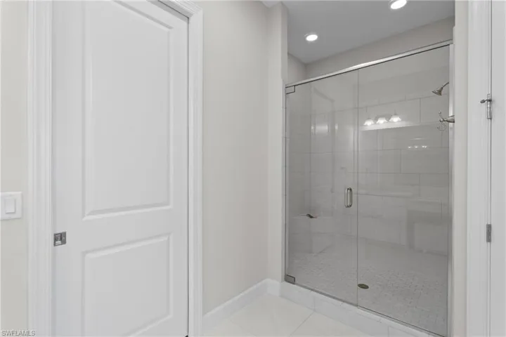 Full bathroom with tile patterned floors, a stall shower, and recessed lighting
