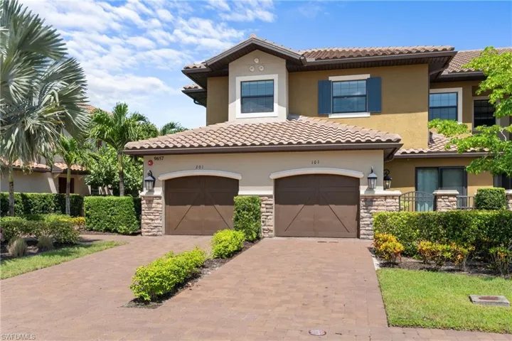 Mediterranean / spanish-style home featuring stone siding, decorative driveway, a garage, and stucco siding