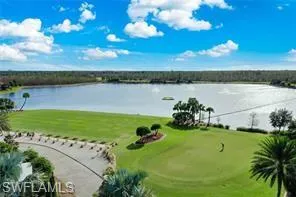 View of home's community featuring a water view and a yard