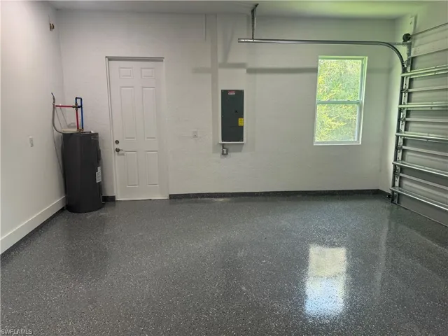 Garage with water heater and electric panel