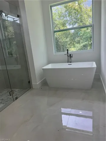 Bathroom featuring a washtub and tile patterned floors