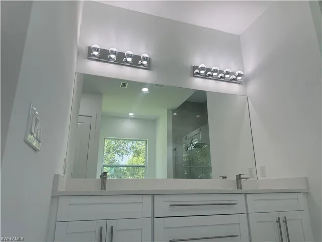 Bathroom featuring vanity and walk in shower