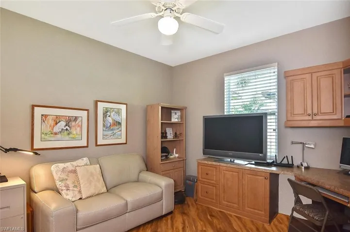 Office area featuring ceiling fan and wood finished floors