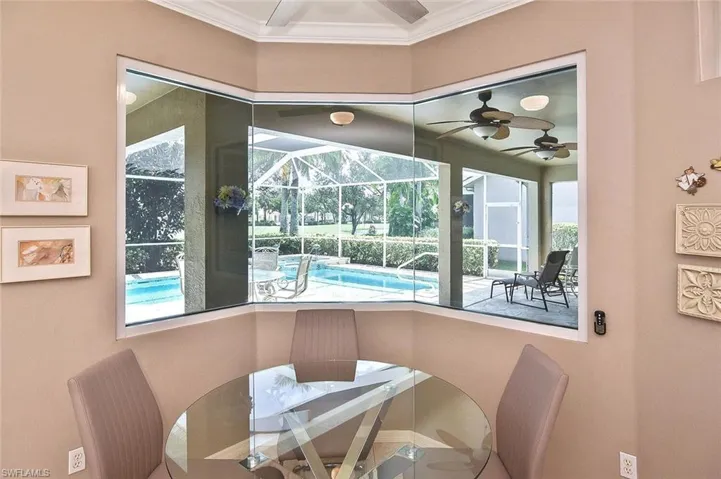 Dining room with ornamental molding, a sunroom, ceiling fan, and plenty of natural light