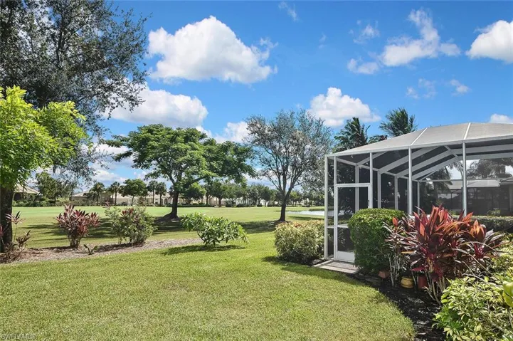 View of grassy yard featuring a lanai