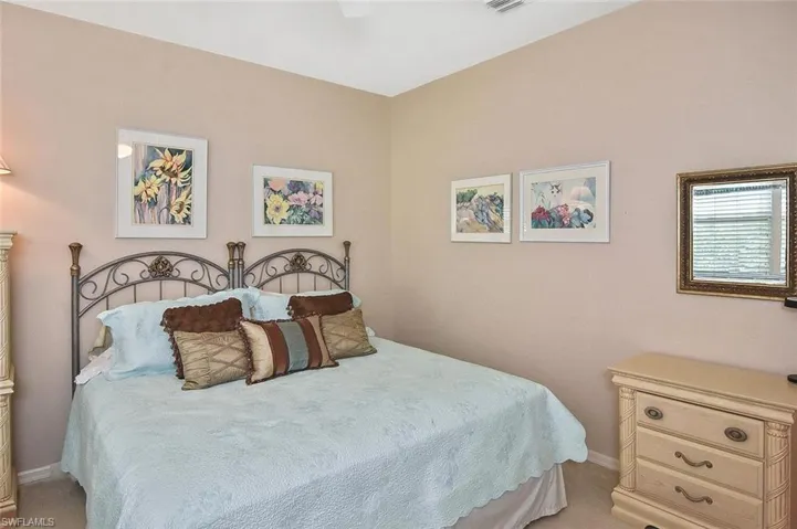 Bedroom featuring baseboards and light carpet