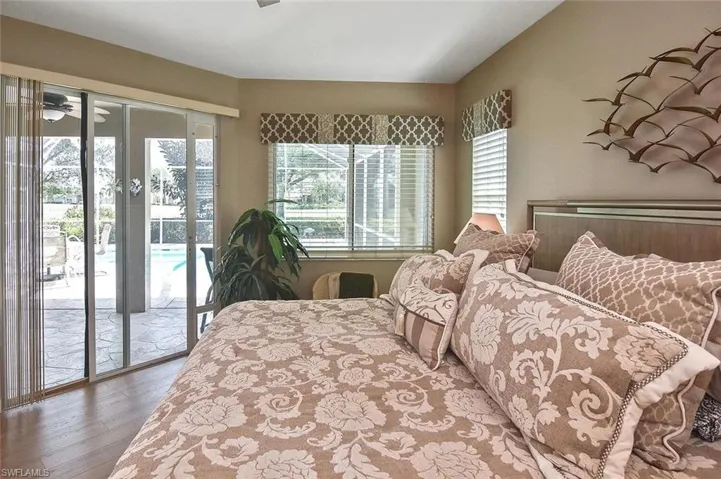 Bedroom with access to outside and wood finished floors