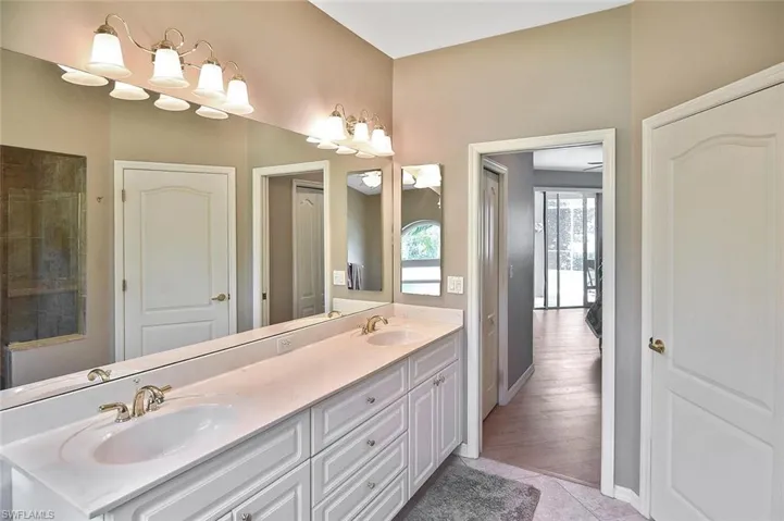 Full bath with double vanity and tile patterned flooring