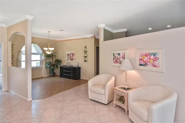Sitting room featuring a chandelier, ornamental molding, light tile patterned flooring, and recessed lighting