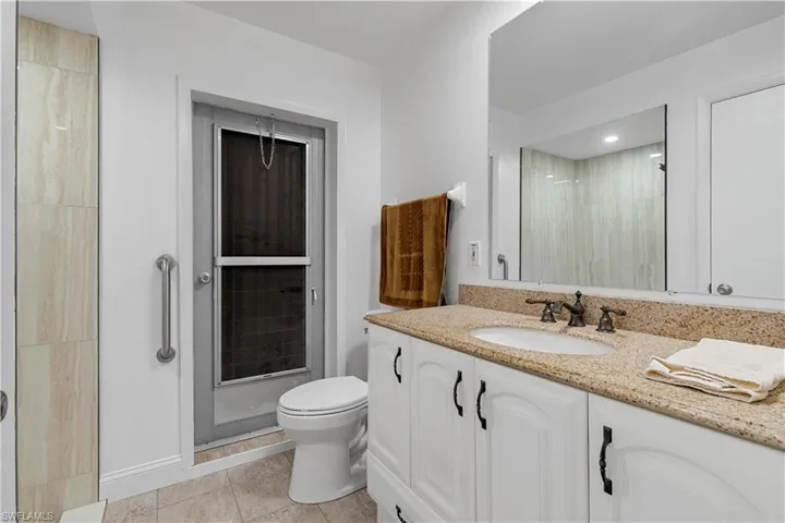 Door out to the pool area from primary bath.