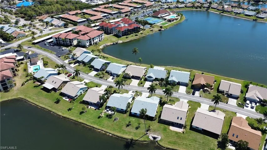 Aerial view of property's location with a nearby body of water and nearby suburban area