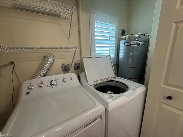 Laundry area with water heater and washer and dryer