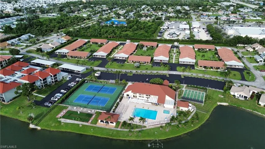 Aerial view of property's location featuring a large body of water and a pool area