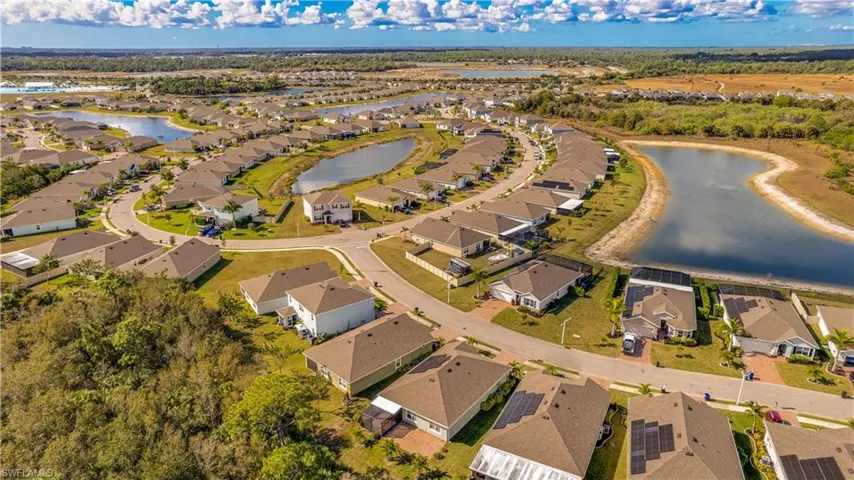 Aerial overview of property's location featuring nearby suburban area and a nearby body of water