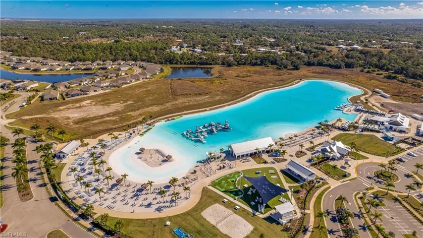 Aerial view of property and surrounding area with a large body of water