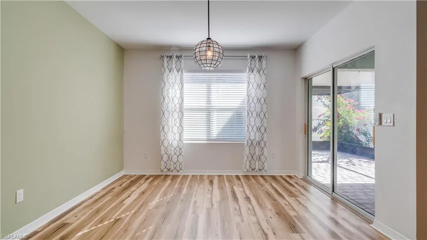 Unfurnished dining area featuring light wood-style floors and baseboards