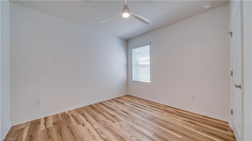 Unfurnished room featuring light wood-style flooring and a ceiling fan