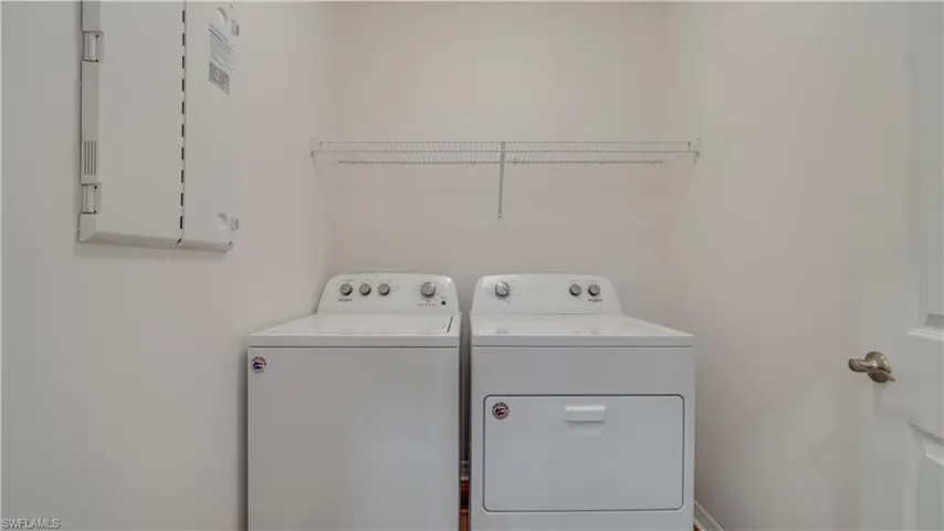 Laundry area featuring washing machine and dryer and electric panel