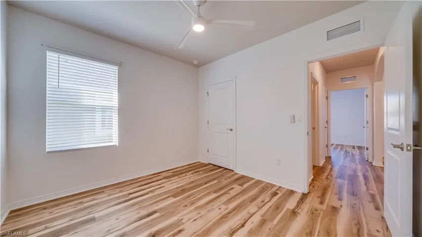 Unfurnished bedroom featuring light wood-type flooring and ceiling fan
