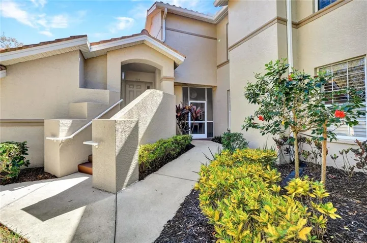 Entrance to property with stucco siding