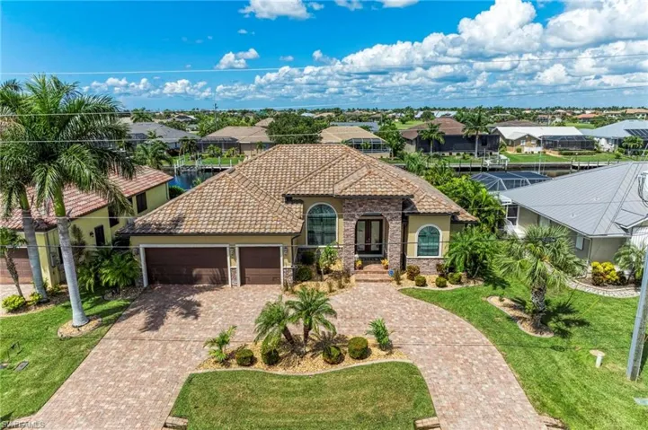 Mediterranean / spanish-style home with a garage and a front yard