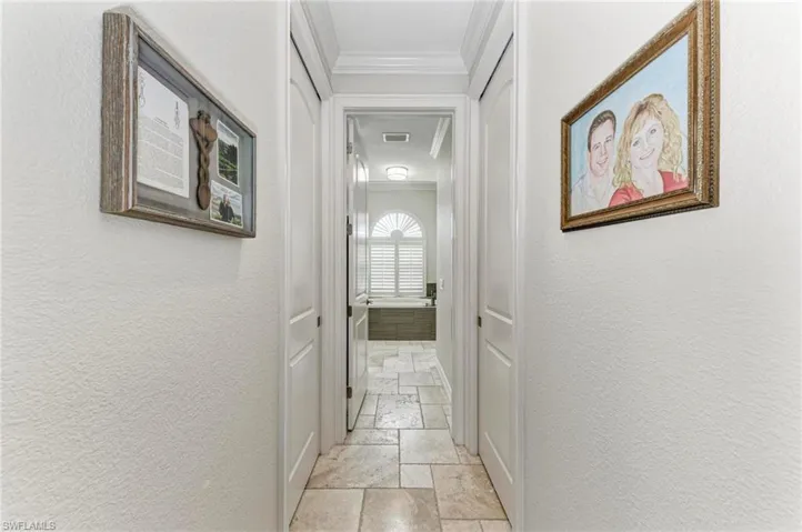 Hallway featuring ornamental molding