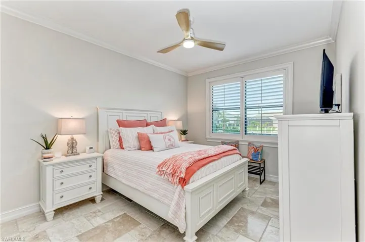 Bedroom featuring ornamental molding and ceiling fan